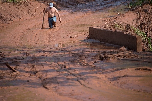 A man tries to cross a muddy area of Gesterio, part of the Barra Longo city, 60 km from Mariana, Brazil on November 07, 2015. Rescuers searched for a third day Saturday the site where an avalanche of mud and mining sludge buried a village in southeastern Brazil, as authorities struggled to pin down the number of dead and missing. AFP PHOTO / CHRISTOPHE SIMON (Photo credit should read CHRISTOPHE SIMON/AFP/Getty Images)