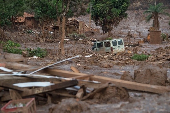 Partial view of mud-covered Bento Rodrigues, three days after an avalanche of mud and mining sludge buried the town in southeastern Brazil, on November 8, 2015. The tragedy left at least 13 people dead, with the fate of 15 others still unknown, the governor of Minas Gerais state Fernando Pimentel told reporters. AFP PHOTO / CHRISTOPHE SIMON (Photo credit should read CHRISTOPHE SIMON/AFP/Getty Images)