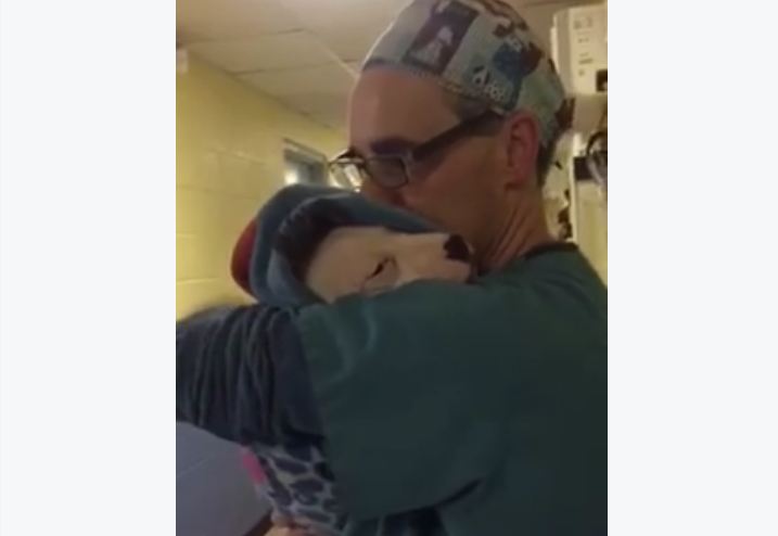 Vet Comforts Dog After Surgery By Rocking Her Like A Baby