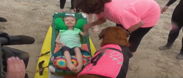 Kids with Spinal Muscular Atrophy Get Once-In-A-Lifetime Chance to Ride Waves with Surfing Dog